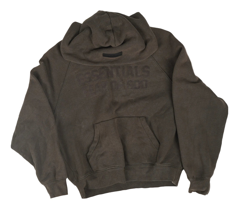 A dark brown, washed cotton hoodie with 'ESSENTIALS WEAR OF GOD' printed in a faded, tonal font across the chest, laid flat on a light gray background.