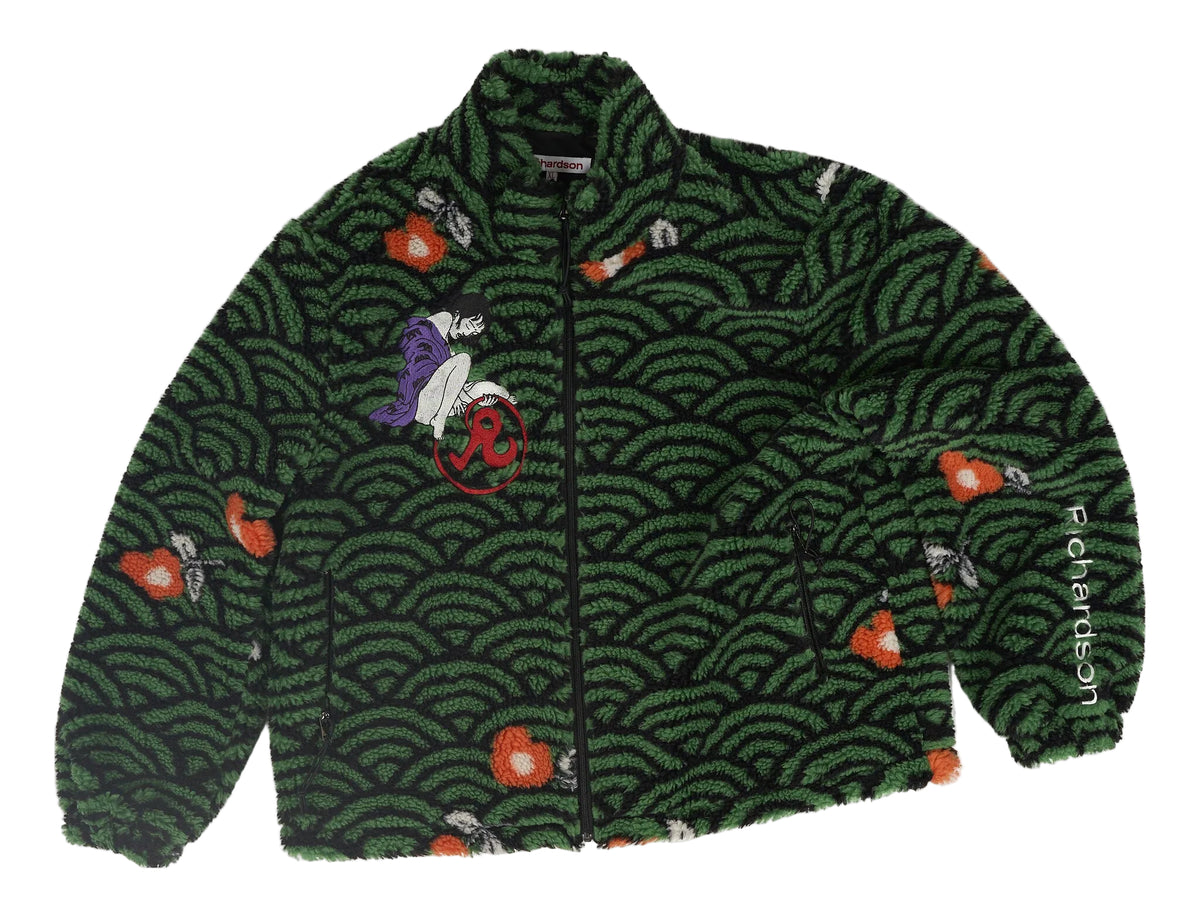 A dark green fleece jacket featuring a repeating black and green wave pattern, decorated with small red and orange fish, a purple and white character patch on the chest, and 'Petersen's' printed vertically on the right sleeve.